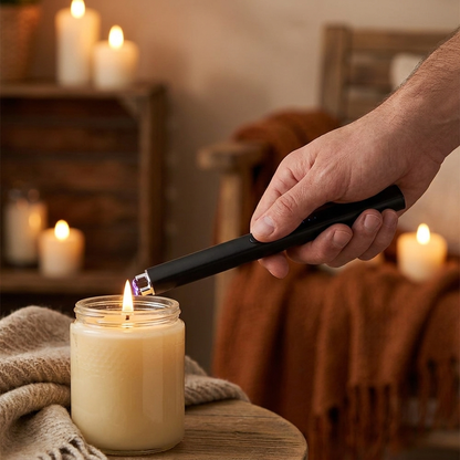Hand using the Apex Arc Lighter to light a candle